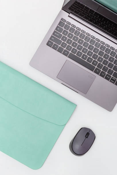 istock Lifestyle work space for student, office worker, freelancer. Modern education concept. Gray laptop in blue case and wireless mouse. Top view. Flat lay. 1179351122