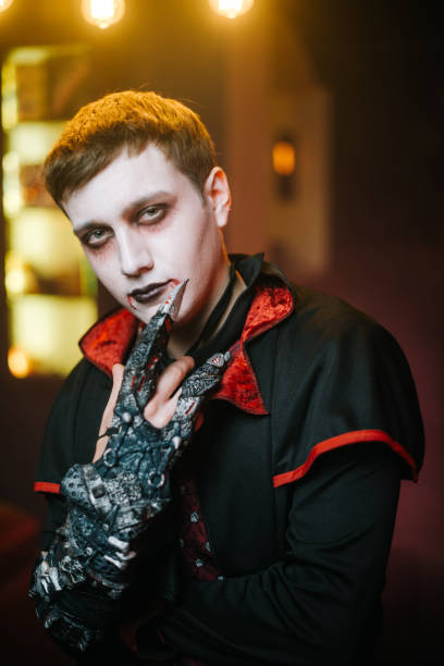 istock Young man in a Halloween costume, Count Dracula, looks at the camera 1179351486