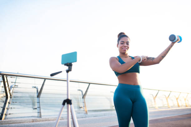istock Tattooed plump woman telling about building arm muscles 1179352612