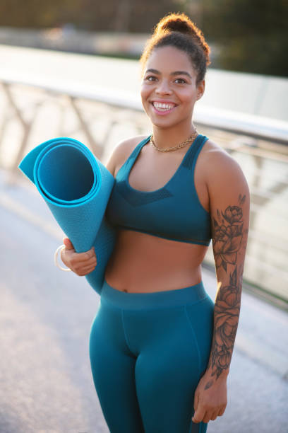 istock Plump smiling woman holding sport mat while heading to training 1179352639