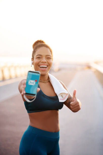 istock Smiling young sportswoman smiling after receiving message 1179352855