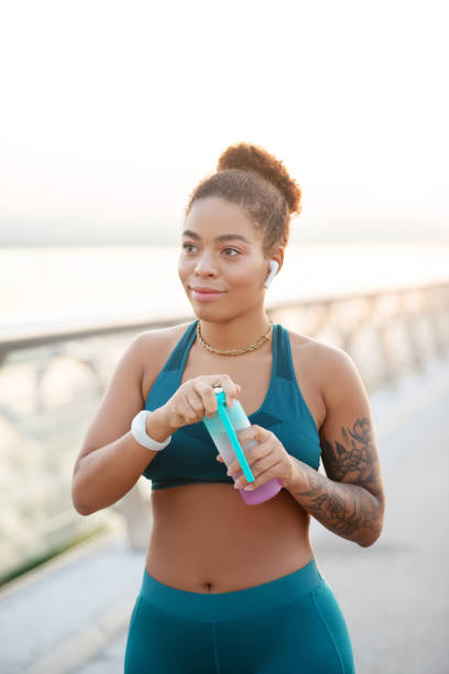 istock Woman drinking some water after intensive run 1179353447