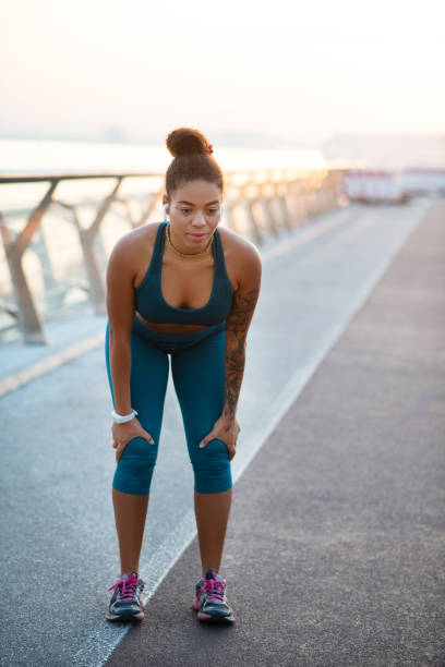 istock Dark-skinned woman wearing leggings feeling exhausted after run 1179353478