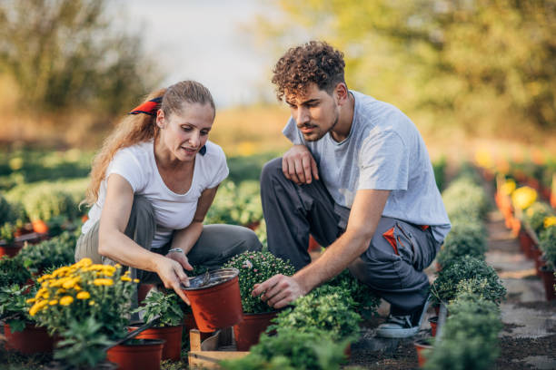 istock Man and woman nursery flowers 1179353553