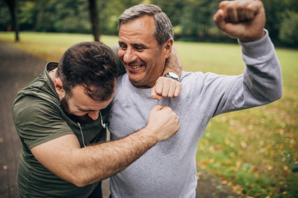 istock Father and son jogging in park 1179353653