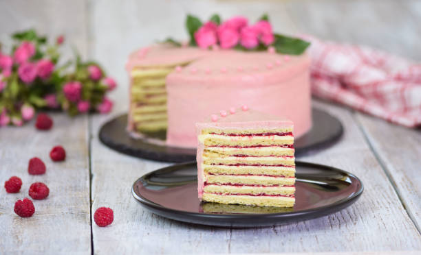 istock Slice of layered creamy fruit cake. Raspberry layer cake. 1179354983