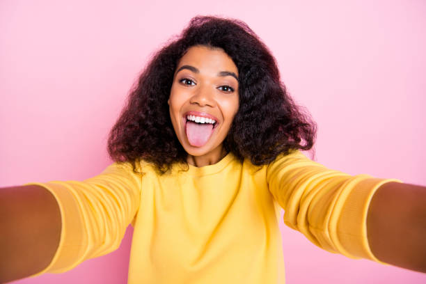 istock Self-portrait of nice glad optimistic cool careless with exotic appearance shiny summer time spending hipster showing tongue taking selfie for followers isolated pastel color background 1179356311
