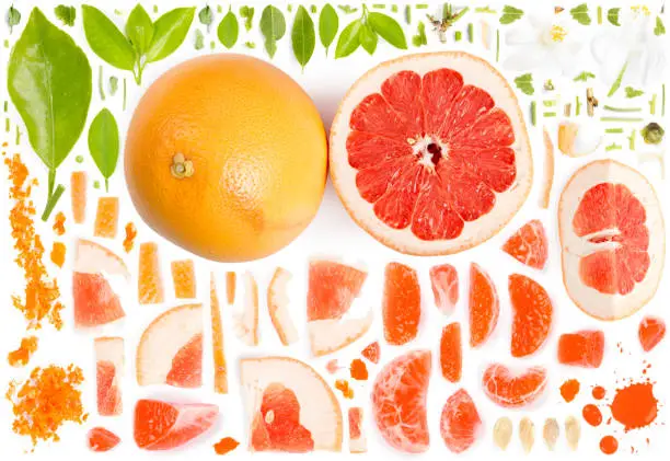 Large collection of grapefruit pieces, slices and leaves isolated on white background. Top view. Seamless abstract pattern.