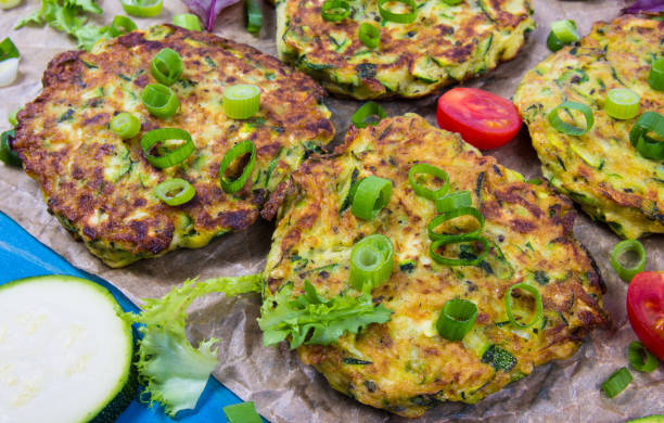 istock Zucchini pancakes with chives on a wooden table. 1179358136