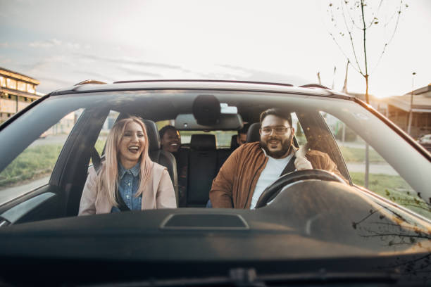 istock Happy friends driving in a car 1179360305