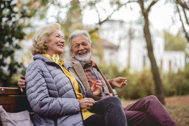 istock Senior Couple enjoying autumn in a park 1179360486