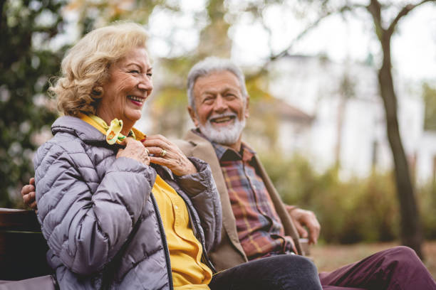 istock Senior Couple enjoying autumn in a park 1179360694