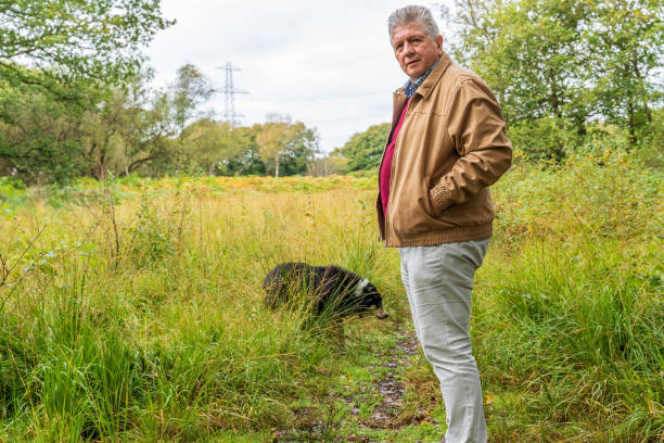 istock Active senior man with dog in countryside 1179361750