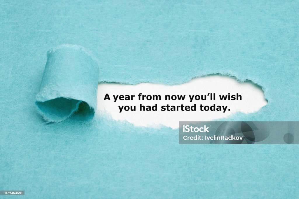 You Will Wish You Had Started Today Motivational quote "A year from now you will wish you had started today" appearing behind torn blue paper. Change Stock Photo