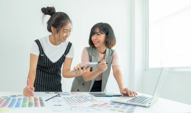 istock Coworking process. Designers team working modern office. Young creative manager showing new startup idea monitor. Designer graphic creative creativity work laptop. 1179365189