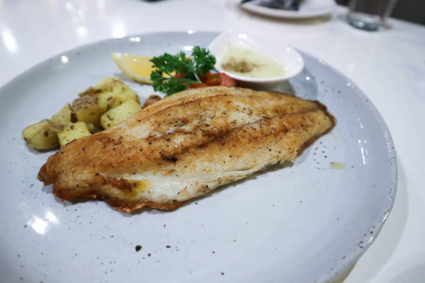 istock fish steak with white cream sauce and vegetable 1179365245