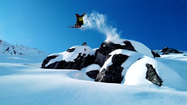 Skier jumping into fresh powder