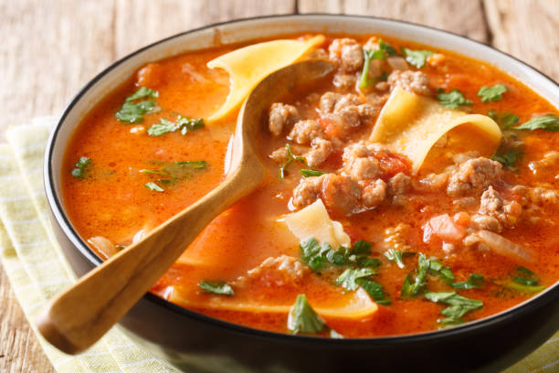 Homemade thick lasagna soup with minced meat closeup. horizontal