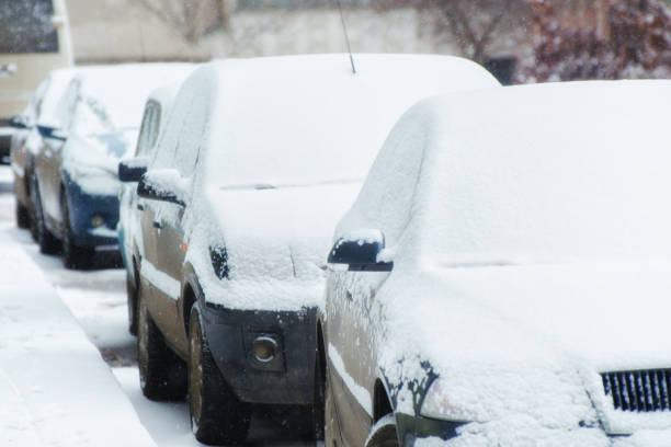 istock Parked cars covered in fresh snow after blizzard. 1179370295