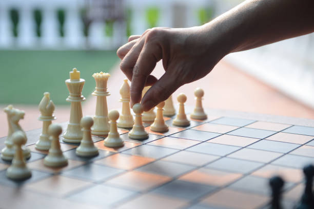 istock Close up of hand confident man playing chess game 1179370900