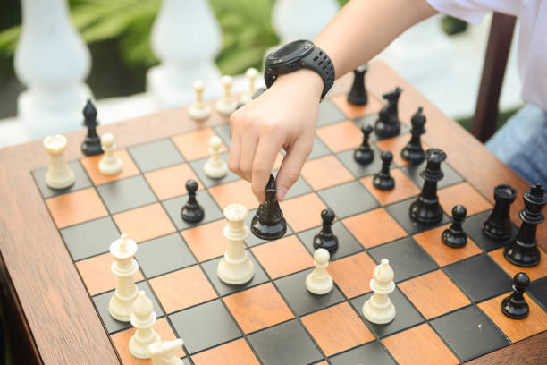 Close up of hand confident man playing chess game