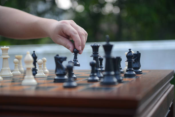 Close up of hand confident man playing chess game