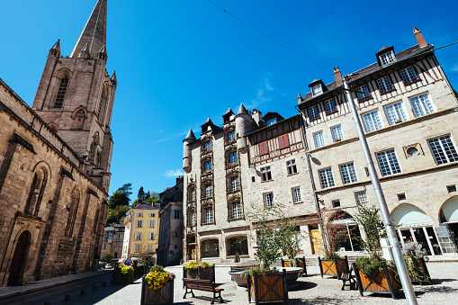 panoramic view on the facades of historic houses at Aachen market square with fountain at blue late summer day