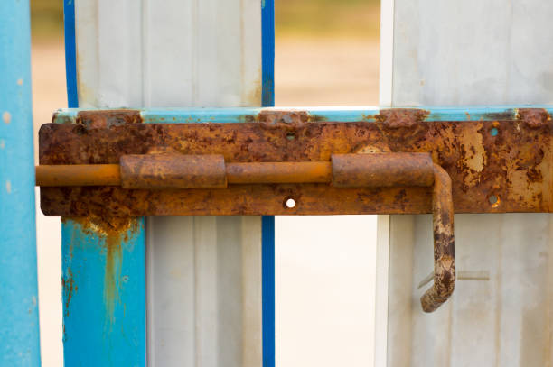 istock A rusty old bolt on the metal doors. 1179377187