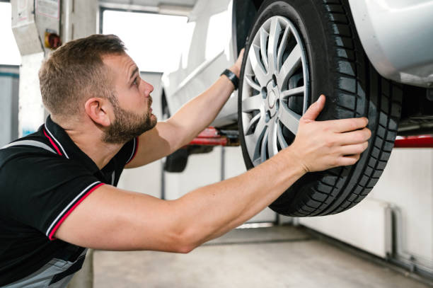 istock Car mechanic is changing tire 1179377340