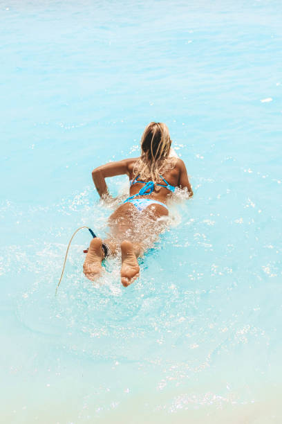 istock Women in the water on the surfboard 1179377758