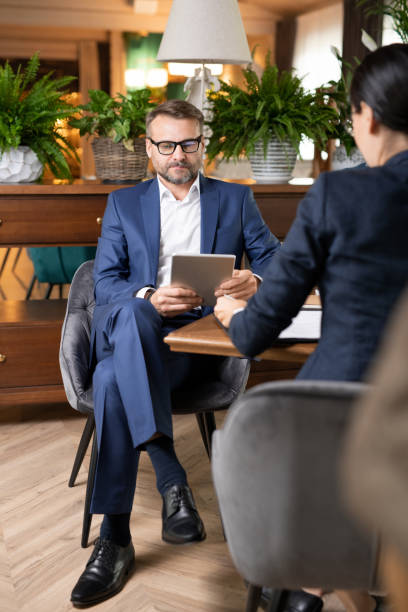 istock Busy employee in suit sitting by table in restaurant and scrolling in touchpad 1179382674