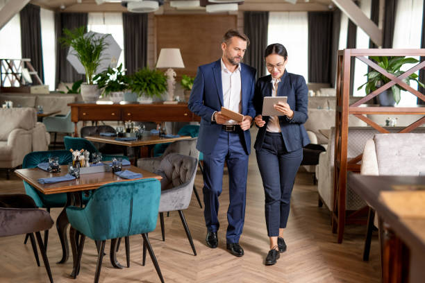 istock Two business partners walking along restaurant and discussing online data 1179383317