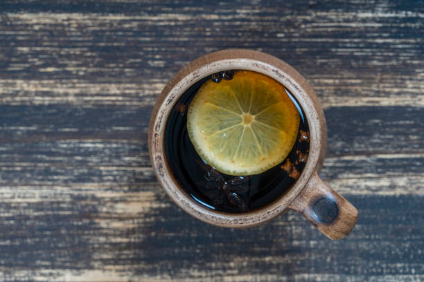 Spice tea, consisting of cinnamon, black pepper, cardamom, star anise, lemon, cloves and hot apple juice. Close up, top view Spice tea, consisting of cinnamon, black pepper, cardamom, star anise, lemon, cloves and hot apple juice. Close up, top view. Cinnamon tea. Tea drink ayurveda cardamom star anise spice stock pictures, royalty-free photos & images