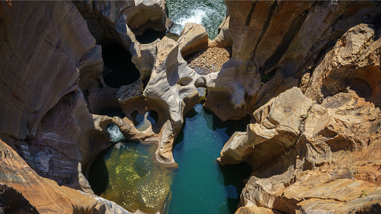 steep walls of red sandstone at bourkes luck potholes, mpumalanga, blyde river canyon, south africa