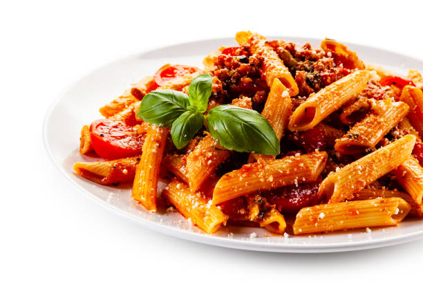 istock Penne with meat, tomato sauce and parmesan on white background 1179386721
