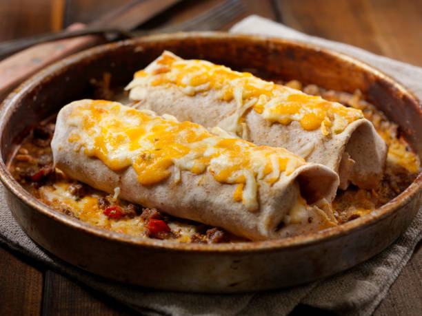 Cheesy Baked Beef Burrito Cheesy Baked Beef Burrito mexican culture food mexican cuisine fajita stock pictures, royalty-free photos & images