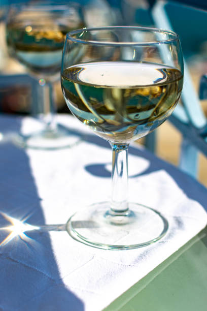 istock White wine served outside on balcony on glass table with sea view 1179389221