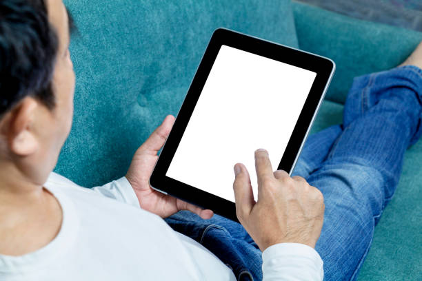istock Man hands holding tablet lying on sofa ordering online food on touch screen. Delivery service food shopping concept for order online. Business and technology with lifestyle in city. 1179390300