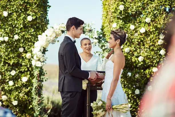 Shot of a happy young couple getting married in a garden