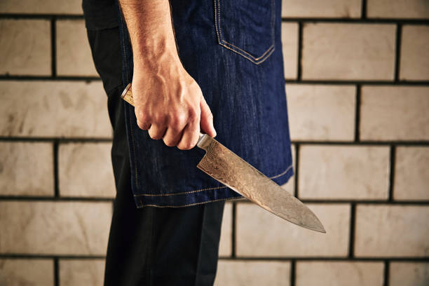 istock Young chef in kitchen holding knife. Food concept. 1179390541