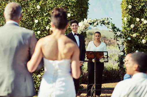 Shot of a mature man walking his daughter down the aisle while her groom waits at the wedding altar