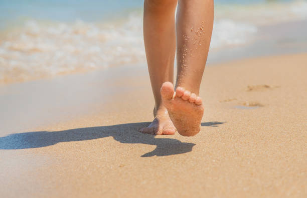 istock child walks along the beach leaving footprints in the sand. Selective focus. 1179394170