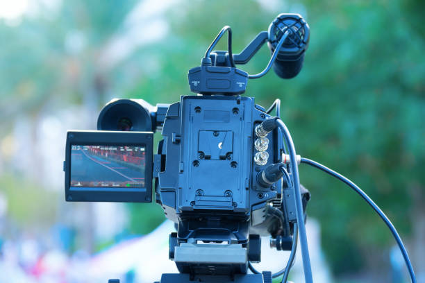 istock High end professional digital video camera with LCD screen and microphone at an outdoor event 1179395394