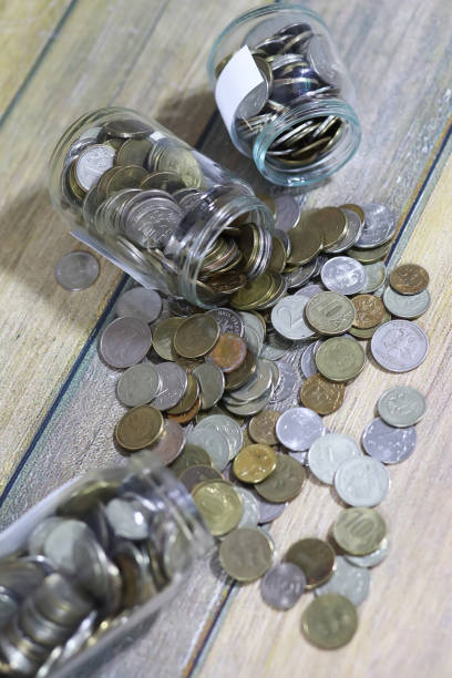istock Accumulated coins stacked in glass jars 1179401657