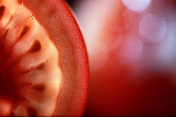 istock Red tomato cut in half with the texture of seeds 1179402124