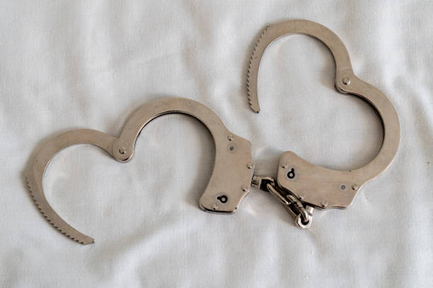 Handcuffs with white heart-shaped background.
