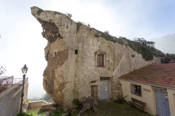 house built inside a rock in Sedini Sedini, Italy - December 31, 2018: a house built inside a rock in Sedini, Sardinia, Italy castelsardo photos stock pictures, royalty-free photos & images