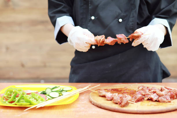istock The cook cuts meat for cooking barbecue 1179403680