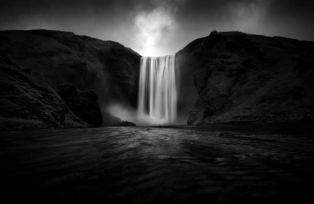 istock Black and white view to stunning Skogafoss waterfall. 1179403975