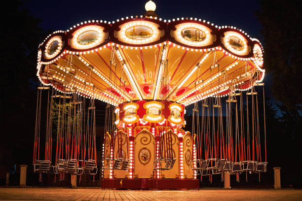 istock Illuminated swing chain carousel in amusement park at the night 1179404589